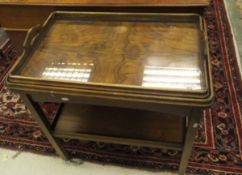 An early to mid 20th Century walnut tea trolley with glass bottomed tray top on square supports