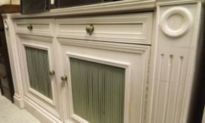 A white painted side cabinet with two drawers over two cupboard doors,
