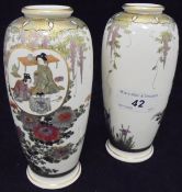 A pair of Japanese Satsuma vases with panels of figures in interior settings amongst trailing