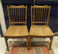 A set of four oak slat back dining chairs with curved panel seats on square supports