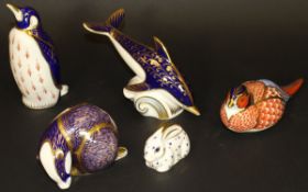A Royal Crown Derby figure of a dolphin, badger, penguin, pheasant and a smaller rabbit,