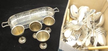 A box of various cutlery, egg cups,