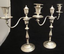 A pair of William IV silver candlesticks of fluted baluster form, on circular bases,