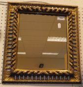 A Florentine style carved gilt wood and gesso rectangular framed wall mirror