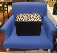 A modern armchair of large proportions, with blue upholstery,