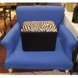 A modern armchair of large proportions, with blue upholstery,