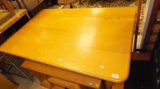 A modern oak table, the plain top above turned and ringed legs,