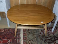 A light elm Ercol beech oval coffee table with slatted under tier CONDITION REPORTS