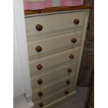 A pine topped and cream painted chest of six drawers to plinth base