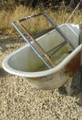 A cast iron bath decorative feet and two radiators,