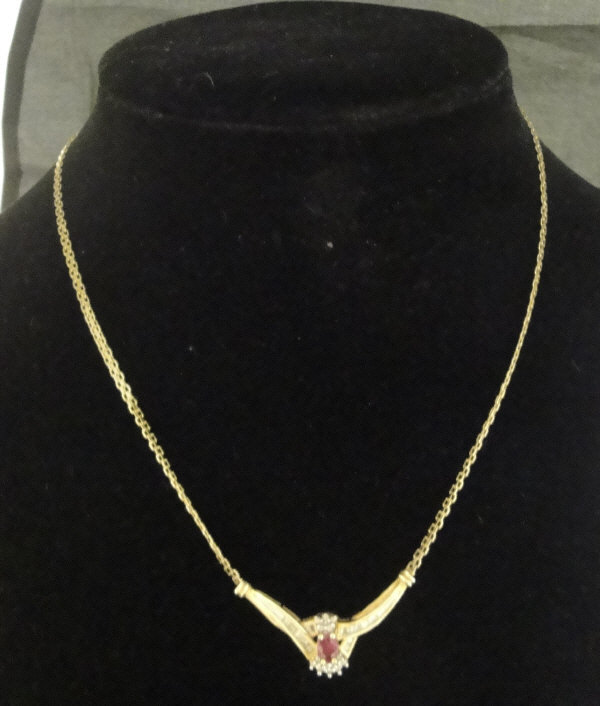 A 10 carat gold mounted ruby and diamond pendant necklace,