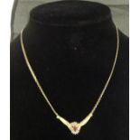 A 10 carat gold mounted ruby and diamond pendant necklace,