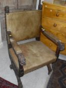 An oak throne/hall chair with leather seat, back and padded arm rests,