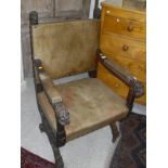 An oak throne/hall chair with leather seat, back and padded arm rests,