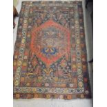 A Caucasian rug, the central panel set with a lozenge shaped medallion on a blue ground,