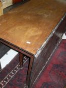 A 19th Century mahogany drop leaf table on square section tapering legs to brass caps and castors