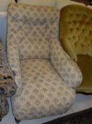 A Victorian Howard style button back armchair, raised on turned and ringed front legs,