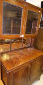 A 19th Century mahogany dresser with two glazed doors enclosing shelves above a mirrored back,