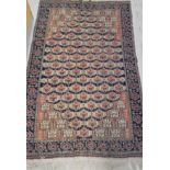 A Turkoman rug, the central panel set with repeating geometric motifs on a blue and red ground,