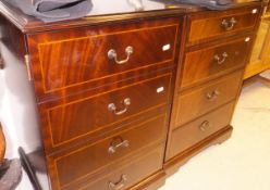 A pair of modern mahogany bedside cabinets, the plain tops above a false door of four drawers,