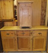 A Victorian pine dresser, the plain top above three drawers to three cupboard doors,