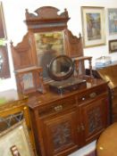 A Victorian mahogany sideboard with mirrored superstructure over two drawers and two cupboard doors,