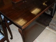 An early 20th Century mahogany drop leaf table raised on cabriole legs to pad feet together with