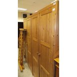 A pair of modern pine two door wardrobes,