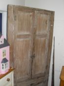 A Victorian bleached pine corner cupboard with two panel doors above two short doors