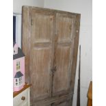 A Victorian bleached pine corner cupboard with two panel doors above two short doors