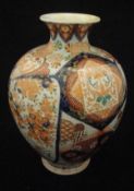 A late 19th Century Japanese satsuma ware baluster shaped vase with medallion and floral spray