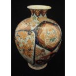 A late 19th Century Japanese satsuma ware baluster shaped vase with medallion and floral spray