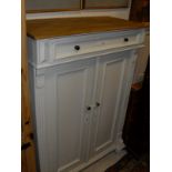 A continental pine and cream painted cupboard,