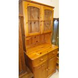 A modern pine dresser, the glazed top above two drawers and two cupboard doors,