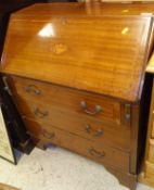 An Edwardian mahogany and inlaid bureau, the plain top above a drop front to three long drawers,