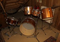 A modern six piece drum kit with snare, bass, tom toms, etc, together with two pairs of drum sticks,