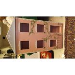 A modern pink painted wooden three tier dolls' house