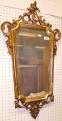 A 19th Century gilt wood and gesso wall mirror of tapered rectangular form with C scroll and