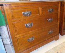 A pair of Edwardian walnut chests of drawers,