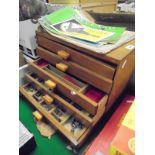 A wooden five drawer chest containing a quantity of various vintage Meccano,