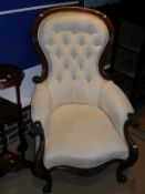 A pair of Victorian mahogany framed spoon back salon chairs in cream button-back upholstery