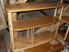 A light elm Ercol three tier trolley of oblong form together with a light elm Ercol coffee table