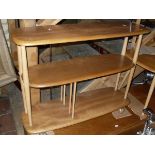 A light elm Ercol three tier trolley of oblong form together with a light elm Ercol coffee table