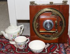 Vintage camera and plates and lenses together with a childs tea set decorated with floral sprays