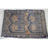 A Caucasian prayer rug in shades of pale terracotta, blue and taupe,