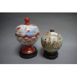 A Kutani ware globular bowl and cover on wood stand;