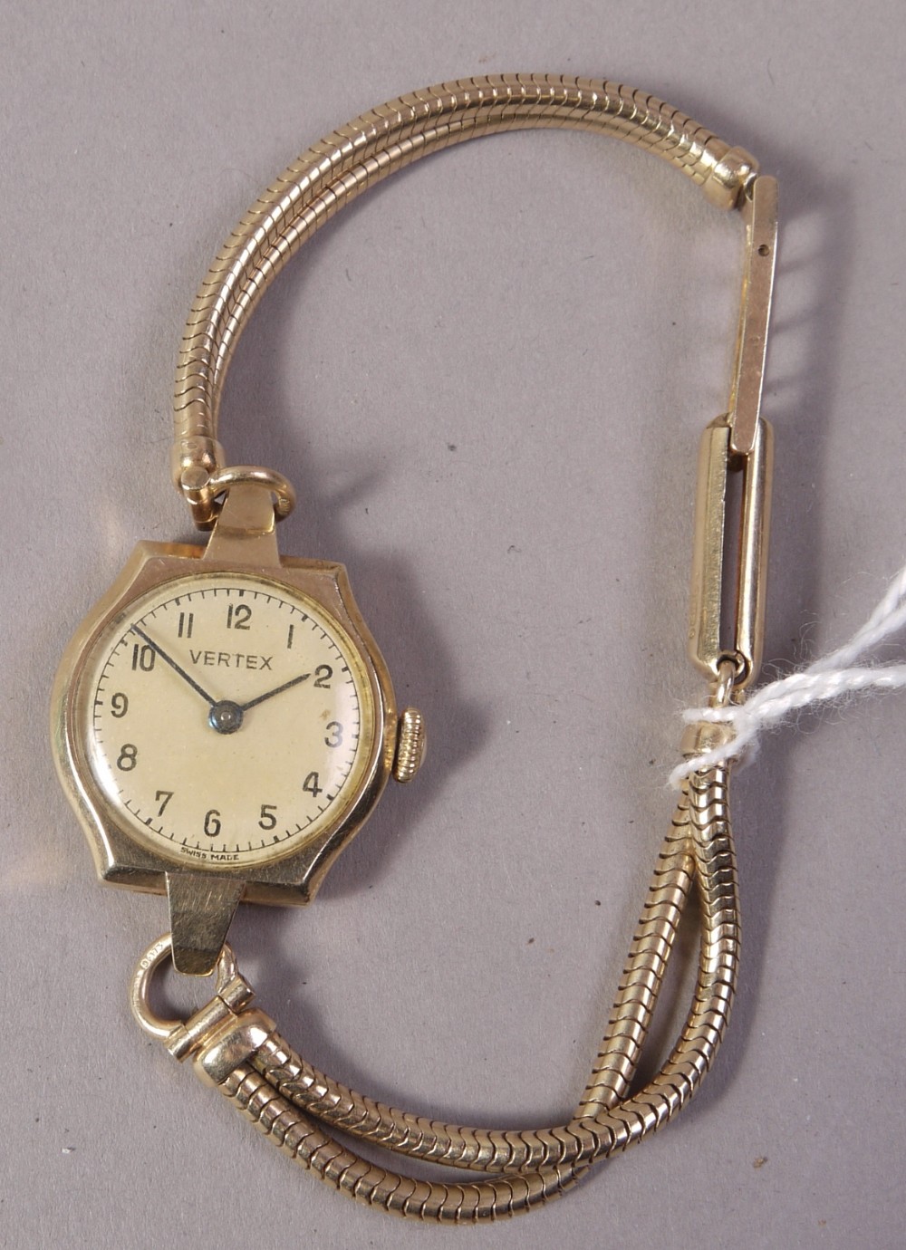 A lady's wristwatch by Vertex in a 9ct gold tonneau case on a twin strand foxtail bracelet in 9ct