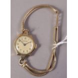 A lady's wristwatch by Vertex in a 9ct gold tonneau case on a twin strand foxtail bracelet in 9ct