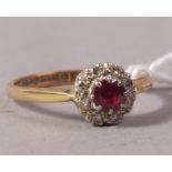 A ruby and diamond cluster ring in 18ct gold,