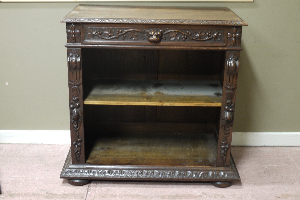 A Victorian carved oak side cabinet with lion mask and fruiting leaf carved frieze, carved uprights,